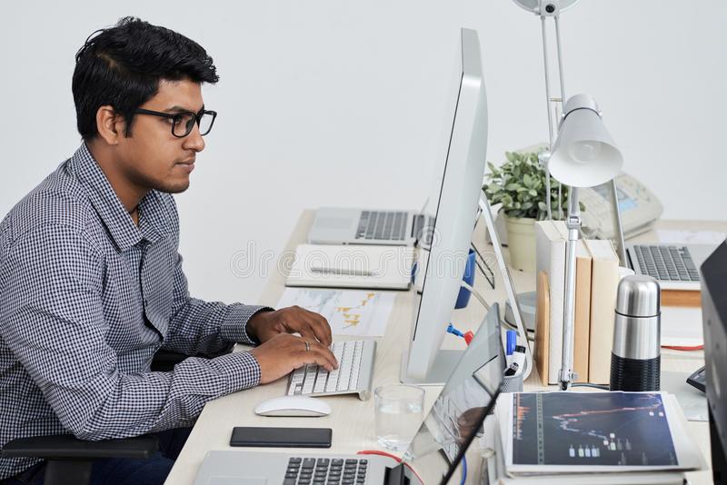 working-developer-indian-software-computer-his-office-table-114804165